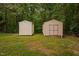 Two sheds are featured in the back yard surrounded by trees at 231 Harris Rd, Smithfield, NC 27577