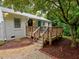 Backyard view with deck, landscaping, and lawn space at 2409 Derby Dr, Raleigh, NC 27610