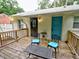 Cozy outdoor wooden deck featuring a table, chairs with blue cushions, and access to the backyard at 2409 Derby Dr, Raleigh, NC 27610