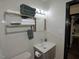 A bathroom showcasing a vanity, sink, towel rack with neatly folded towels, and illuminated mirror at 2409 Derby Dr, Raleigh, NC 27610