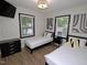 Inviting bedroom with two beds, natural light, and contemporary decor at 2409 Derby Dr, Raleigh, NC 27610