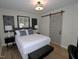 Bright bedroom featuring a queen-sized bed, stylish sliding door, and modern furnishings at 2409 Derby Dr, Raleigh, NC 27610