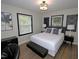 Comfortable bedroom with accent wall, modern décor, and ample natural light at 2409 Derby Dr, Raleigh, NC 27610
