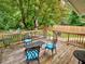 Wooden deck furnished with seating, offering a view of the expansive, tree-filled backyard at 2409 Derby Dr, Raleigh, NC 27610
