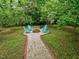 Backyard fire pit with Adirondack chairs provides a cozy and inviting outdoor gathering space at 2409 Derby Dr, Raleigh, NC 27610