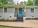 Charming home featuring a quaint front entrance with a bright blue door, and manicured landscaping at 2409 Derby Dr, Raleigh, NC 27610