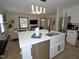 Bright, open-concept kitchen featuring a large island with a sink and stainless steel appliances at 2409 Derby Dr, Raleigh, NC 27610