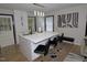 Kitchen island with a white countertop and seating, complemented by sleek cabinetry and stylish lighting at 2409 Derby Dr, Raleigh, NC 27610