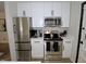 Well-equipped kitchen with stainless steel appliances and white cabinets; offers modern convenience at 2409 Derby Dr, Raleigh, NC 27610