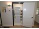 Convenient laundry closet with stacked washer and dryer plus built-in shelving at 2409 Derby Dr, Raleigh, NC 27610