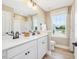 Bright bathroom with double vanity, white cabinets, undermount sinks and large window at 243 Steel Springs Ln # 25, Angier, NC 27501
