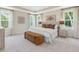 Beautiful bedroom with tray ceiling, bench, two bedside tables, and large windows at 243 Steel Springs Ln # 25, Angier, NC 27501