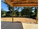 Unfinished covered patio with a view of lush trees and natural surroundings at 243 Steel Springs Ln # 25, Angier, NC 27501