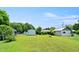 Spacious backyard with several storage buildings and lush green grass at 2527 Ossipee Front St, Elon, NC 27244