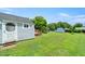 A fenced backyard with storage buildings at 2527 Ossipee Front St, Elon, NC 27244