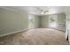 Large bedroom featuring neutral carpet, two windows and natural light at 2527 Ossipee Front St, Elon, NC 27244