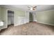 Spacious bedroom with neutral carpet, fan, fireplace, and views of another room at 2527 Ossipee Front St, Elon, NC 27244