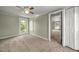 Bedroom featuring neutral carpet, a ceiling fan, a window and an open closet at 2527 Ossipee Front St, Elon, NC 27244
