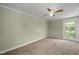 Bedroom featuring neutral carpet, a ceiling fan, and a window with natural light at 2527 Ossipee Front St, Elon, NC 27244