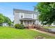 Charming two-story home with a covered front porch and handicap access ramp at 2527 Ossipee Front St, Elon, NC 27244