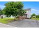 A two-story home with a covered front porch and ramp access, with an asphalt driveway at 2527 Ossipee Front St, Elon, NC 27244
