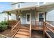 Close up of a covered porch with painted railings and painted support posts at 2527 Ossipee Front St, Elon, NC 27244