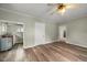 Open kitchen with utility sink, laminate wood floor and access to multiple rooms at 2527 Ossipee Front St, Elon, NC 27244