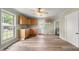 Well lit kitchen features wood cabinets, a window over the sink and wood laminate flooring at 2527 Ossipee Front St, Elon, NC 27244