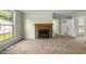 Charming living room with a stone fireplace and views to the backyard at 2527 Ossipee Front St, Elon, NC 27244
