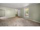 Bright living room with stairway access and a view of the backyard at 2527 Ossipee Front St, Elon, NC 27244