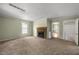 Inviting living room with a cozy stone fireplace and neutral carpet at 2527 Ossipee Front St, Elon, NC 27244