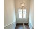 Bright stairwell with wood floors and an elegant hanging light fixture at 2652 Welham Aly, Raleigh, NC 27608