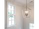 Bright stairwell featuring custom lighting, large windows, and neutral paint tones at 2656 Welham Aly, Raleigh, NC 27608
