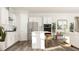 Modern kitchen with white cabinets, stainless steel appliances, an island with bar stools, and a functional layout for cooking at 2924 Ocean Sunrise Dr, Wake Forest, NC 27587