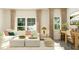 Bright living room featuring a large sectional, neutral colors, and a sunlit window workspace at 2924 Ocean Sunrise Dr, Wake Forest, NC 27587
