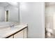 Bathroom with vanity, mirror, and toilet in a well-lit space at 3306 Woodland Park Rd, Durham, NC 27703