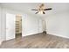 Bedroom featuring laminate floors and closet access at 3306 Woodland Park Rd, Durham, NC 27703