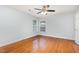 Bright bedroom with hardwood floors, ceiling fan, and natural light from double window at 3306 Woodland Park Rd, Durham, NC 27703