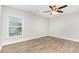 Bright bedroom featuring laminate floors and a window with natural light at 3306 Woodland Park Rd, Durham, NC 27703