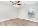 Bedroom featuring wood-look floors, ceiling fan, and window with blinds at 3306 Woodland Park Rd, Durham, NC 27703