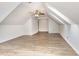 Light, airy bonus room with sloped ceilings and wood-look flooring and ceiling fan at 3306 Woodland Park Rd, Durham, NC 27703