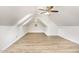 Light, airy bonus room with sloped ceilings, wood-look flooring and round window at 3306 Woodland Park Rd, Durham, NC 27703