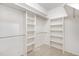 Walk-in closet with adjustable shelving and tile flooring at 3306 Woodland Park Rd, Durham, NC 27703