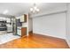 Dining room open to kitchen, hardwood floors, and chandelier lighting at 3306 Woodland Park Rd, Durham, NC 27703