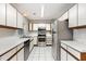 Efficient kitchen with stainless steel appliances and white cabinets providing a modern look at 3306 Woodland Park Rd, Durham, NC 27703