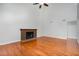 Bright living room with hardwood floors and a brick fireplace for cozy evenings at 3306 Woodland Park Rd, Durham, NC 27703