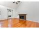 The living room features hardwood floors, a brick fireplace, and plenty of natural light at 3306 Woodland Park Rd, Durham, NC 27703