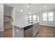 Spacious kitchen with granite countertops, stainless steel appliances, and open layout to the living area at 3916 Well Fleet Dr, Fuquay Varina, NC 27526