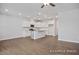 Open kitchen with white cabinets, a center island, stainless steel appliances, and hardwood floors at 3916 Well Fleet Dr, Fuquay Varina, NC 27526
