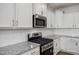 Well-equipped kitchen with white cabinets, subway tile backsplash, and stainless steel appliances at 3916 Well Fleet Dr, Fuquay Varina, NC 27526